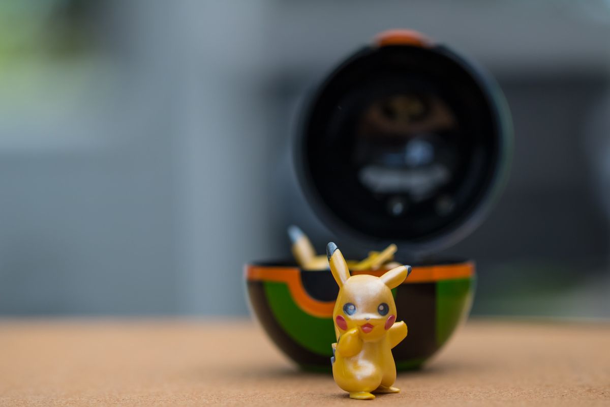 Pikachu in front of a Poke ball