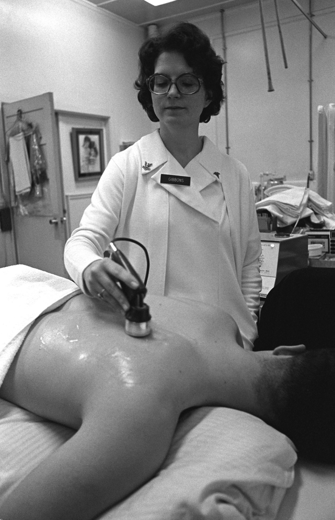 A physical therapist performing ultrasound on military servicemember.